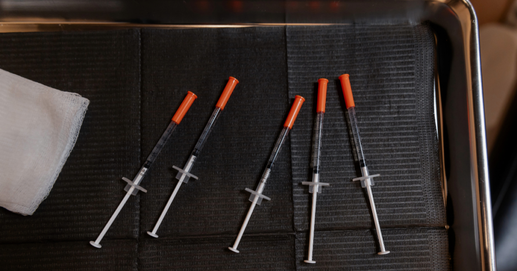Botox syringes on a tray used for hyperhidrosis injection technique and anatomy in neuromodulator treatments for axillary hyperhidrosis.