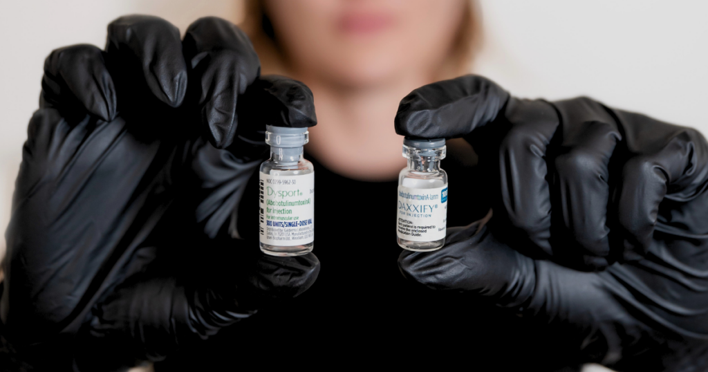 Neuromodulators vials in Lindsay's hands used to teach Botox Basics.